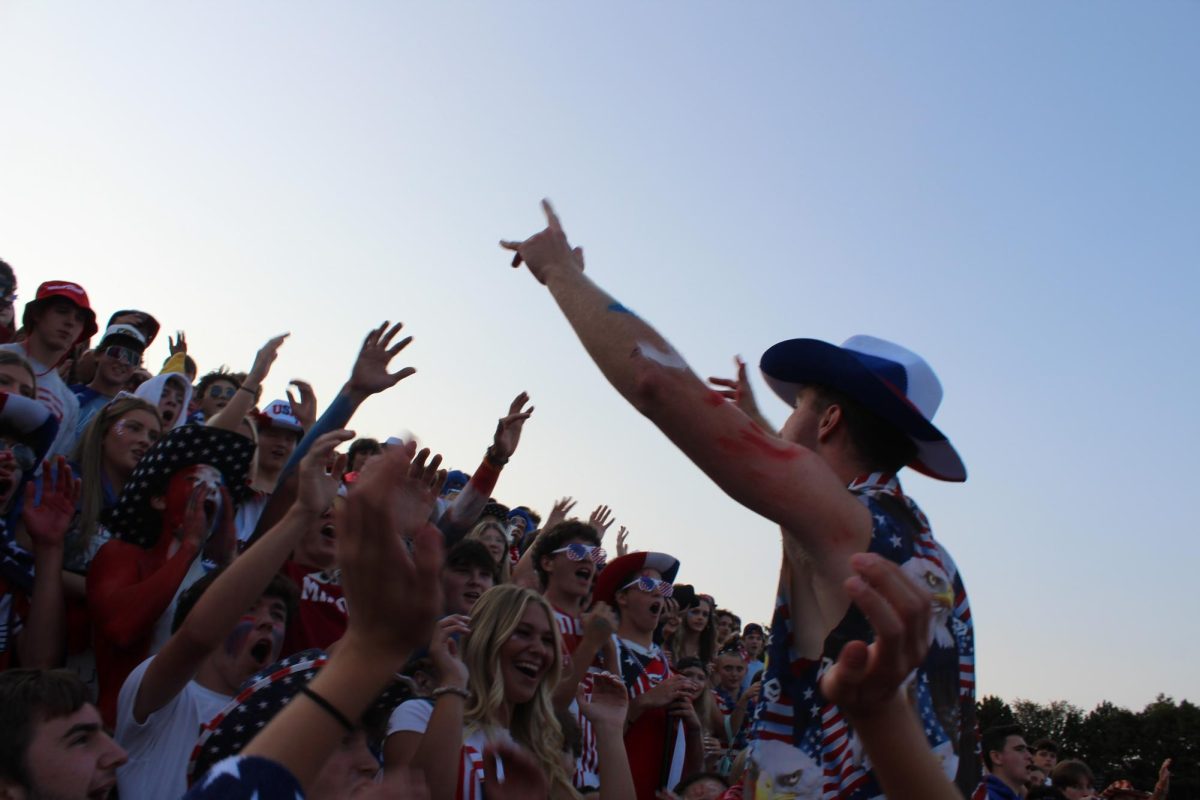 Senior Aidan McCormick hyping up the crowd during Milford's USA out game. 