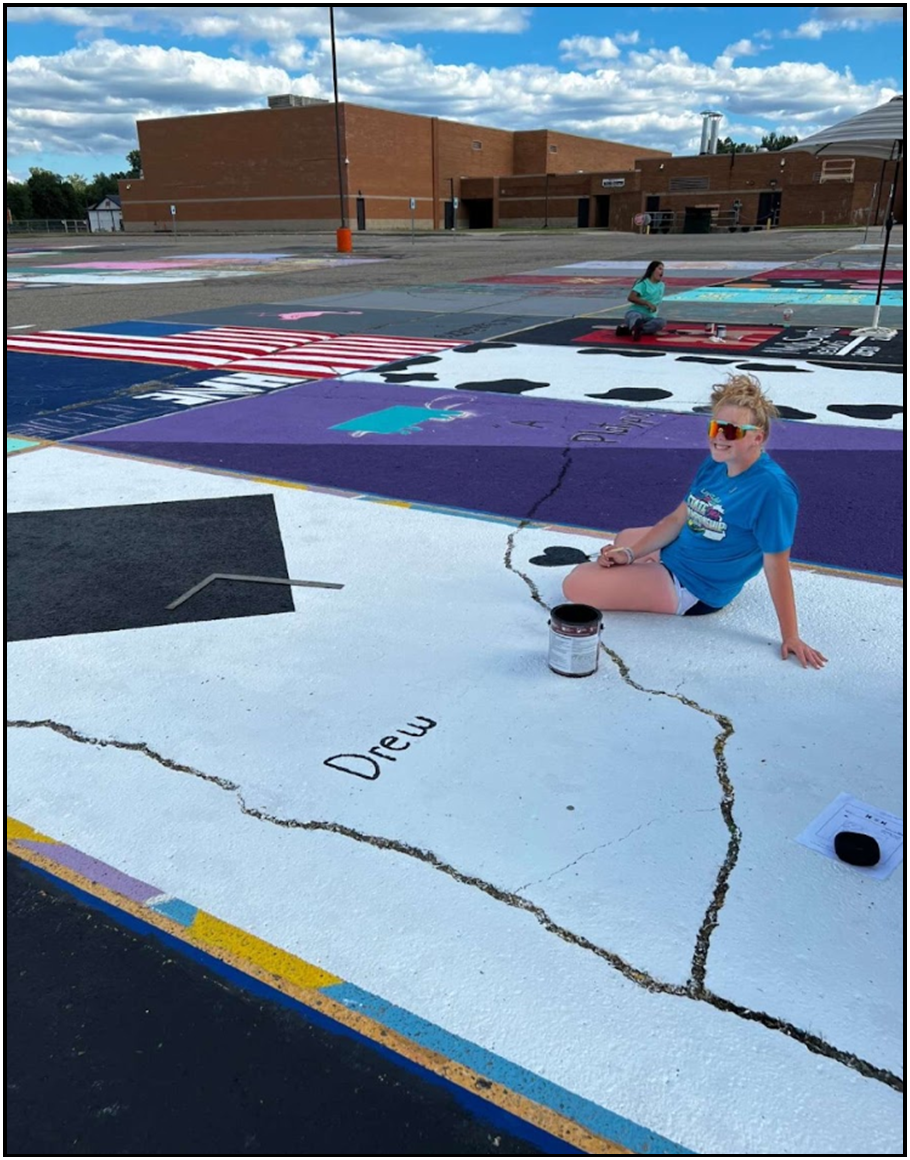 Senior Samantha Leid painting her senior parking spot at Almont Highschool
