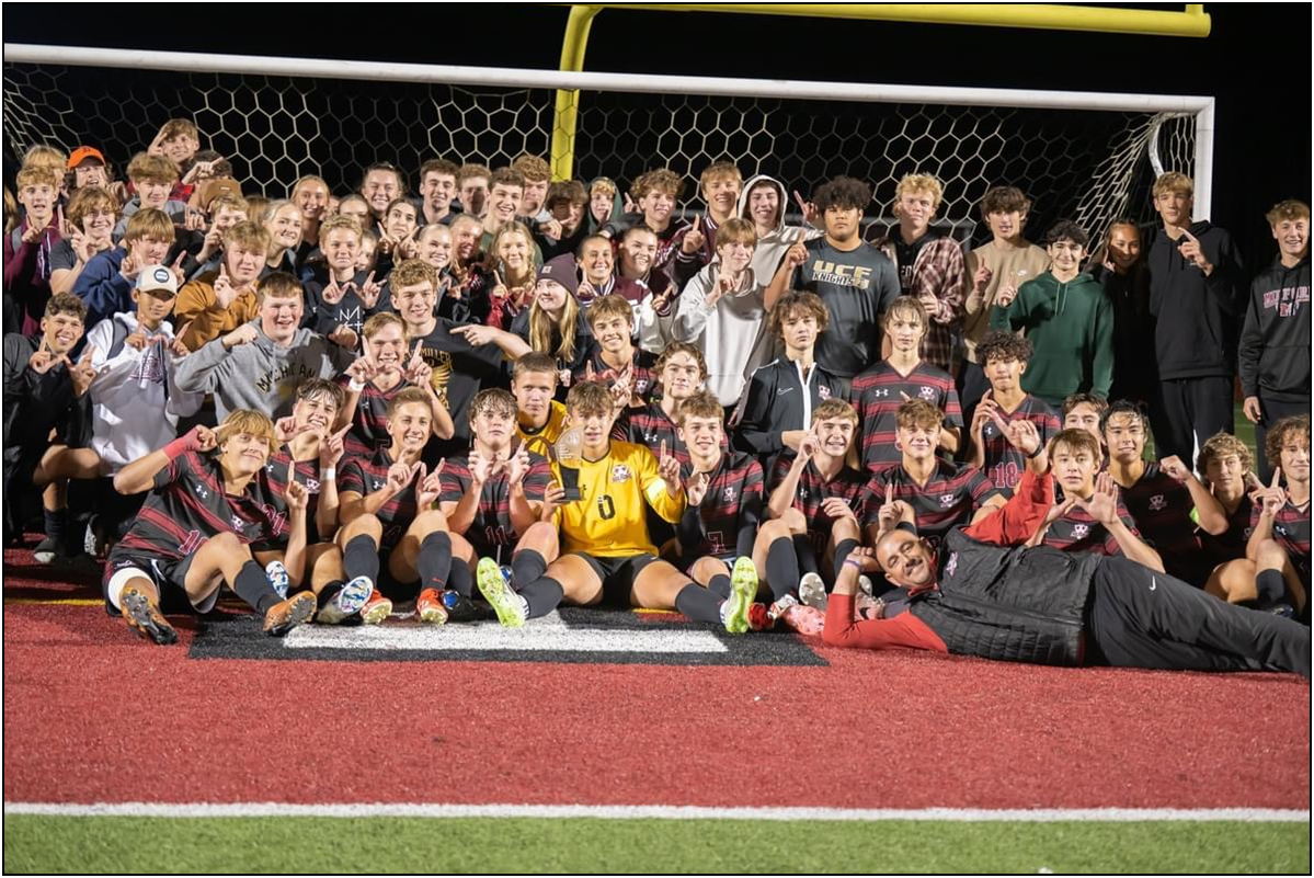 The Milford boys soccer varsity team and community gathered by the net after winning the LVC playoff championship.