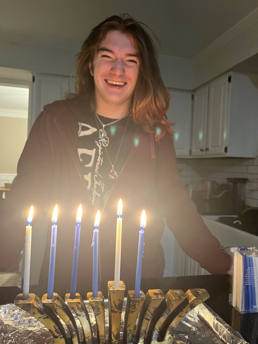 Senior Ari Snider with their menorah on the fifth night of Hanukkah, the day of introspection 