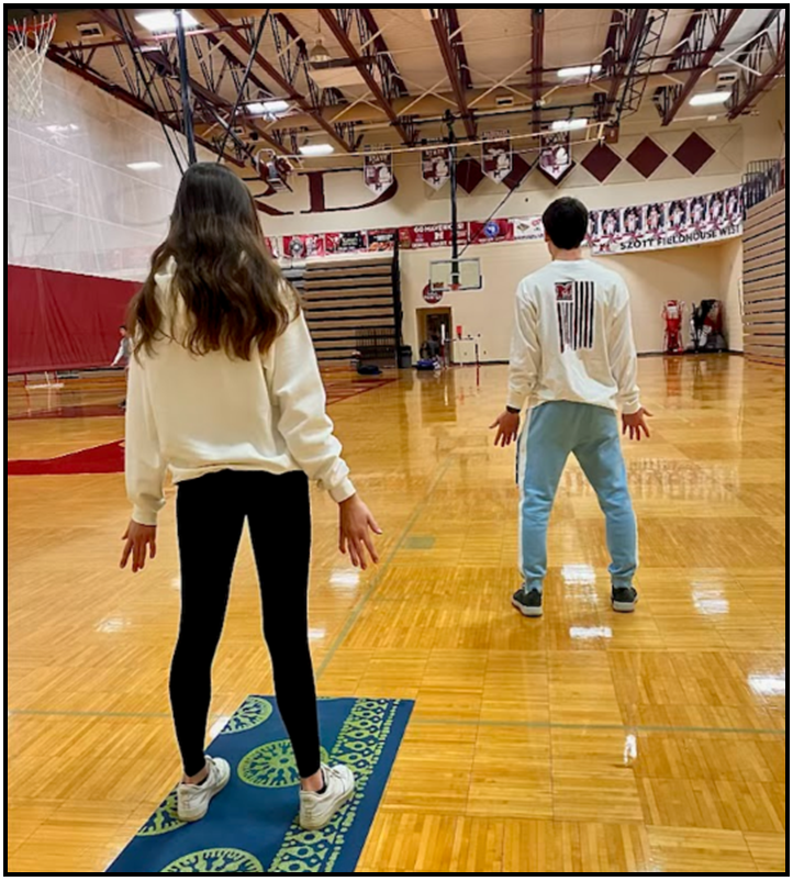 Students practicing mindfulness through the grounding yoga pose ‘the mountain’ (Photo courtesy of Melody Henry). 
