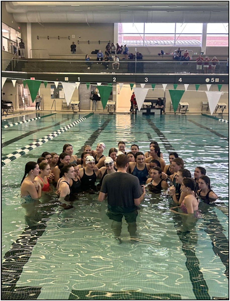 Coach James Schuler having a moment with the girls team after celebrating an astounding win at the conference finals.